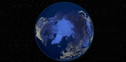 A view of Earth from space focusing on the Arctic region with city lights visible across North America, Europe, and Asia.