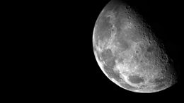 Close-up view of the moon's surface, showing detailed craters and textures.